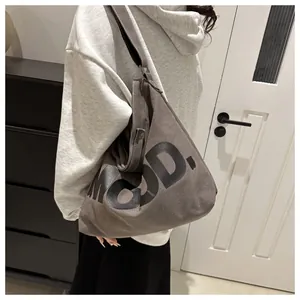 Detail of a large capacity canvas tote bag with bold MOOD letter print in dark grey