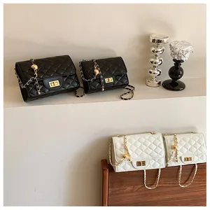 Quilted crossbody chain bags in black and white with gold ball adjustable straps