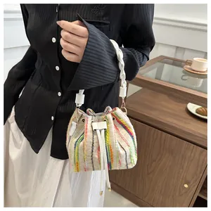Detail of colorful woven vertical stripes and drawstring closure on a bucket bag