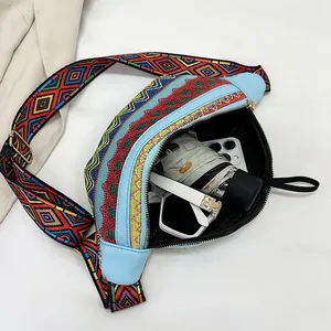 Detail view of ethnic waist bag interior showing capacity for phone, umbrella and sunglasses