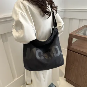 Minimalist black canvas tote bag with MOOD letter print and adjustable shoulder strap