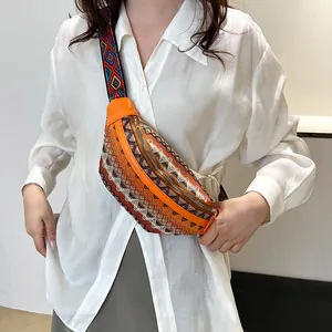 Ethnic style crossbody bag with colorful woven patterns and wide adjustable shoulder strap