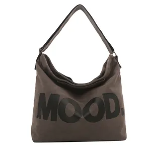 Minimalist dark brown canvas tote bag with MOOD. letter print on white background