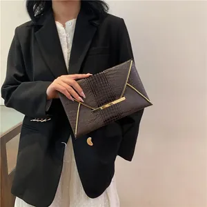 Fashionable dark brown crocodile textured envelope clutch bag with gold metallic trim