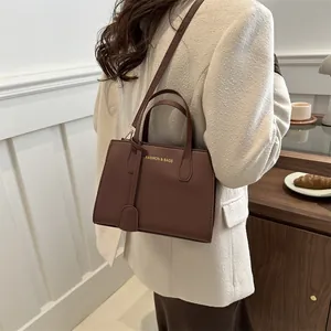 Brown rectangular crossbody handbag in smooth leather shown on model for casual commuting