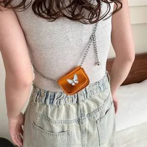 Mini metallic orange crossbody bag with silver chain and white butterfly accent