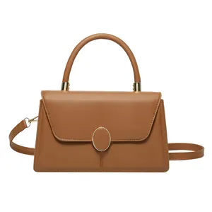Elegant brown leather crossbody handbag with gold clasp and top handle on white background