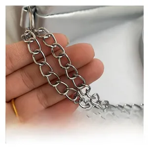 Detail of silver metallic chain strap with oval links on a stylish shoulder bag