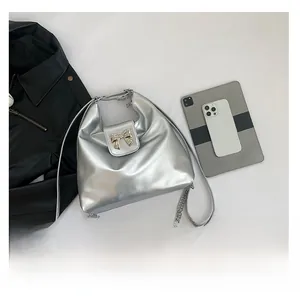 Silver metallic tote bag size comparison with a tablet and phone on white background