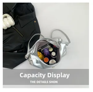 Capacity display of this silver metallic crossbody bag showing interior storage space