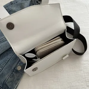 Minimalist white square crossbody bag with wide strap and spacious interior