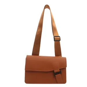 Minimalist caramel rectangle crossbody bag with wide nylon strap and unique buckle