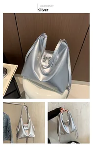 Detail of silver metallic tote bag featuring a chic bow and elegant chain strap