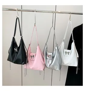 Detail of soft PU bags in four colors featuring silver bow buckles and metal chains