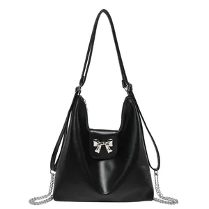 Versatile black PU leather shoulder bag with silver bow accent and chain strap
