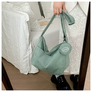 Light green corduroy hobo bag featuring side pocket and matching small round pouch