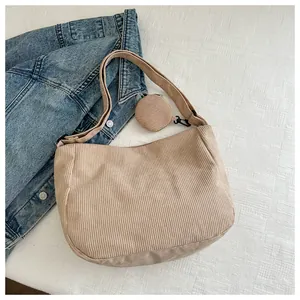 Detail of khaki corduroy dumpling bag with matching round coin purse and metal zipper