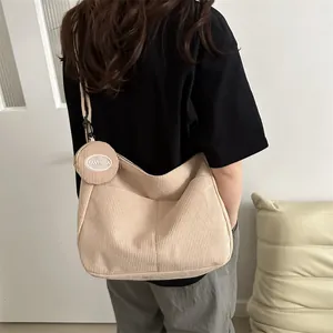 Beige corduroy dumpling crossbody bag with large capacity and a mini matching coin pouch