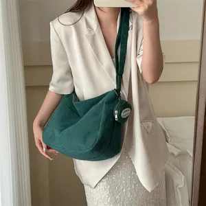 Green corduroy hobo bag with large capacity and a small round coin purse charm