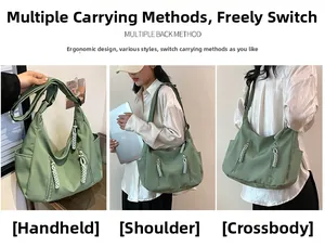 Macro view of sage green nylon tote bag featuring adjustable wide strap and zip detail