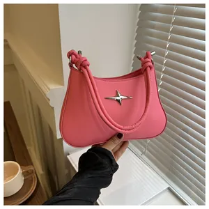 Close-up of pink hobo bag with star metallic buckle and knotted shoulder strap detail