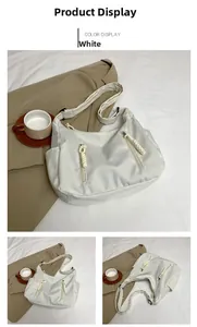 Detail showing white canvas tote bag with decorative zippers and woven rope pulls