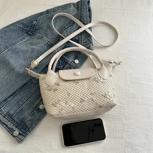 Chic beige straw woven handbag with floral embroidery and adjustable strap for summer