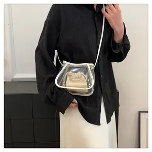 Detailed view of a transparent PVC crossbody bag with a beige canvas inner pouch
