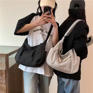 Minimalist large capacity nylon crossbody bag in black and beige with rope zipper pulls