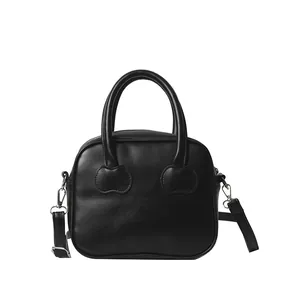 Minimalist black leather handbag with heart-shaped stitching and adjustable strap