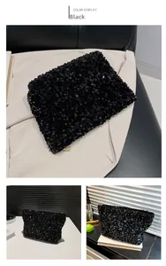 Detail of black sequin clutch bag with high-density finish and gold zipper hardware