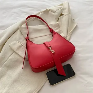 Sac sous le bras rouge vif minimaliste pour femme avec boucle dorée et cuir texturé