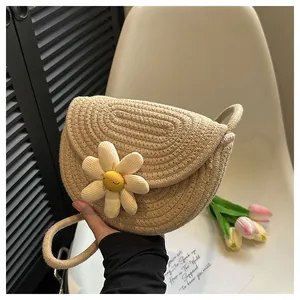 Close-up of woven cotton saddle bag featuring a 3D daisy flower with a smiley face