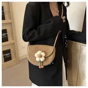 Detail of hand-woven saddle bag featuring a 3D floral decoration and spiral texture