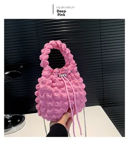 Detail of dark pink bubble textured bucket bag with drawstring and silver metal chain