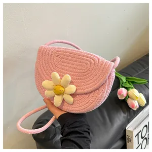 Close-up of pink woven cotton shoulder bag featuring a cute 3D daisy flower detail