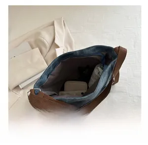 Top view of large capacity denim tote showing folded umbrella and wallet inside