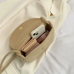 Handmade woven cotton straw shoulder bag with interior space for phone and wallet