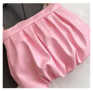 Detail of pink ruched cloud bag showing soft leather texture and premium pleats