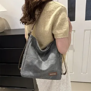Fashionable large grey washed canvas hobo tote bag with brown straps for casual daily use