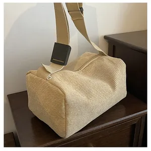 Detail of khaki corduroy crossbody bag texture with wide canvas strap and adjuster