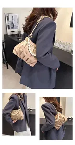 Detail view of khaki pleated cloud bag with pearl chain and adjustable shoulder strap