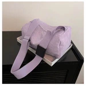 Macro detail of lavender corduroy texture and wide shoulder strap with adjustment buckle