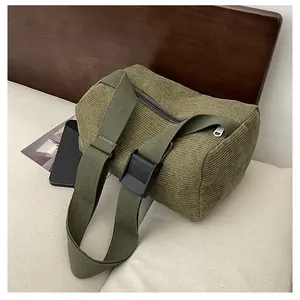 Detail of army green corduroy pillow bag with adjustable strap and metal zipper