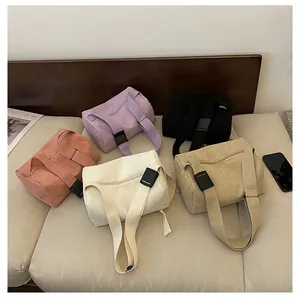 Detailed top view of assorted corduroy barrel bags in pink, purple, black and beige colors