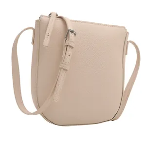 Minimalist beige litchi grain crossbody saddle bag with adjustable strap and zipper