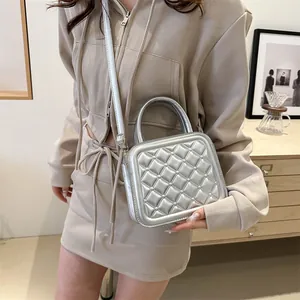 Silver quilted crossbody square bag with metallic finish and top handle for women