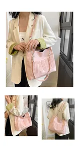 Macro detail of pink TOOHO tote bag showing embossed letters and matte faux leather texture