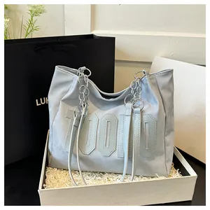 Detail of blue tote bag with 70000 lettering in a minimalist gift box setting