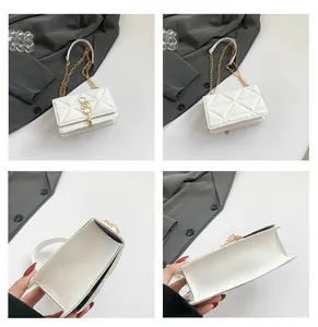Detailed view of white quilted square bag with gold chain strap and tassel hardware